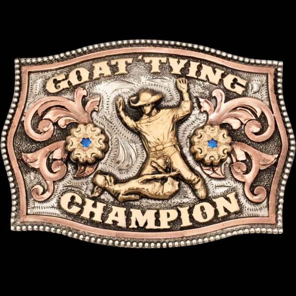 "Rope it, throw it, tie it—fast hands win!""

Our Goat Tying Belt Buckle is a masterpiece, hand-engraved on a German Silver base with a striking three-tone metal design. It features copper Western-inspired scrollwork, Jeweler’s Bronze flo